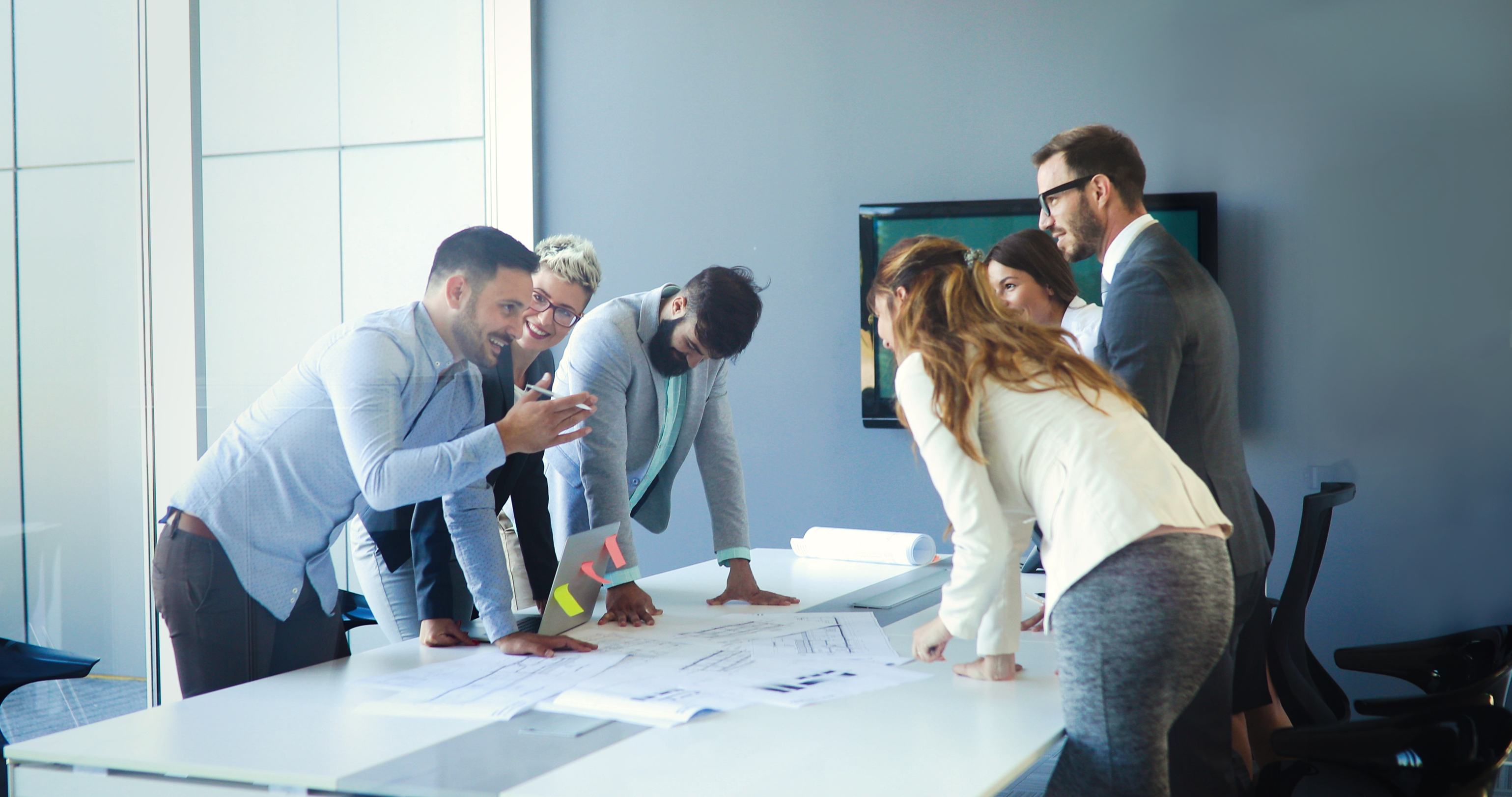 Professionals reviewing large civil plans